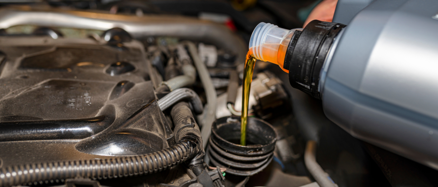 Mechanic pouring engine oil into a vehicle - Car Servicing Bicester